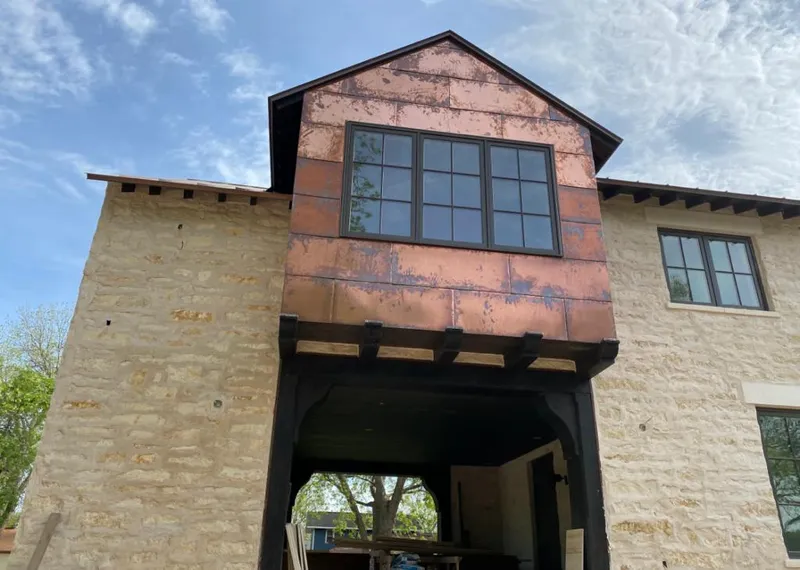 Copper metal panel facade on a stone building for Skylight Installation in Pearland