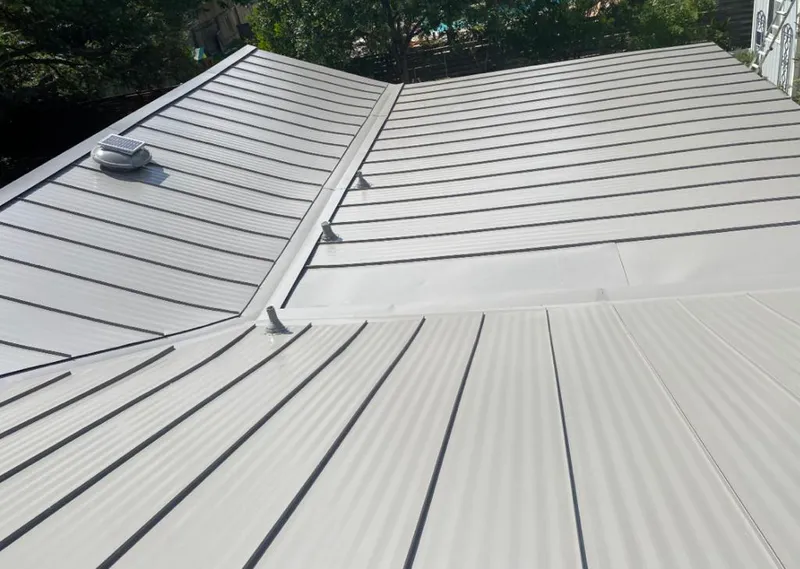 Solar attic fan installed on a metal roof for Roof Ventilation in Pearland